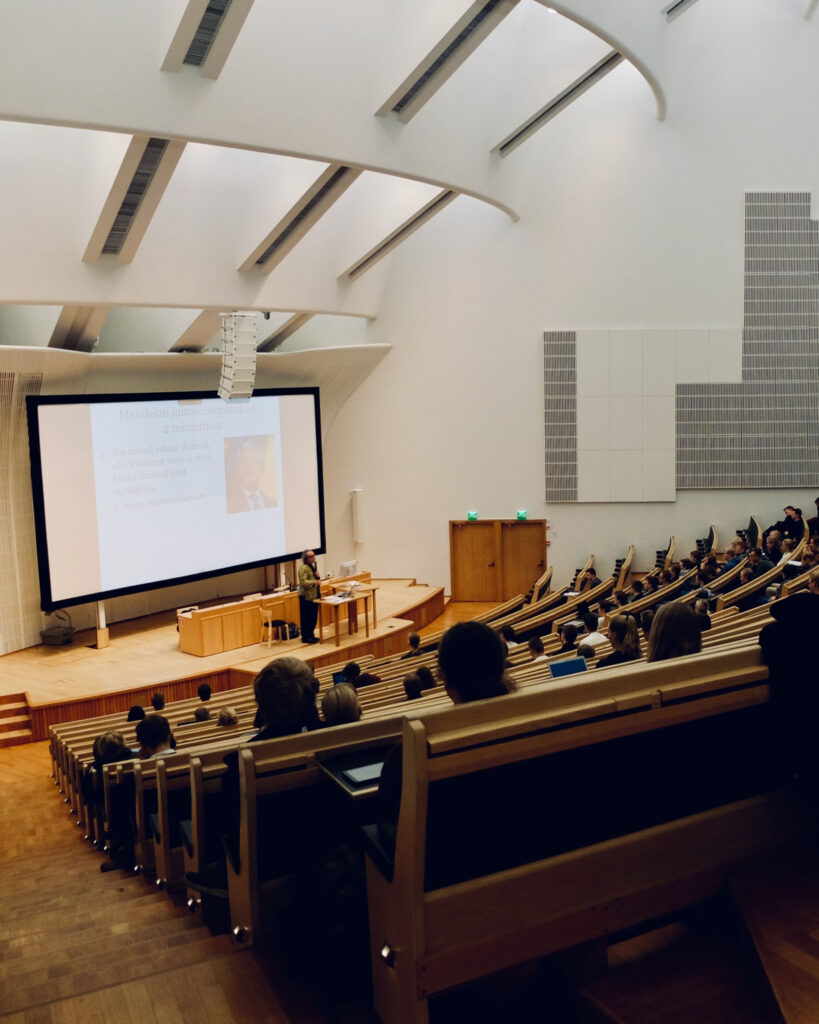 Integrated technology such as audio visual and lighting is in use in a lecture theatre.