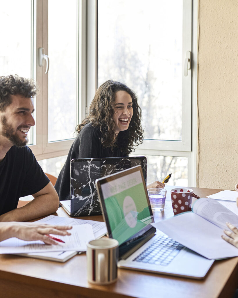 Two people are chatting and working together in managed accommodation.