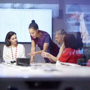 group of people having business meeting, using a video conferencing unit and LCD digital screen