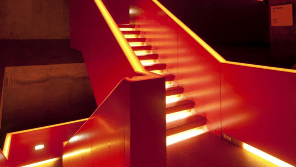 Immersive audio visual technology and feature lighting shown on a staircase. 