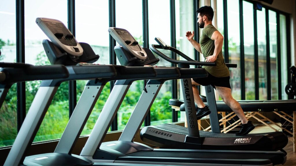 Person using treadmill at gym to show fitness industry